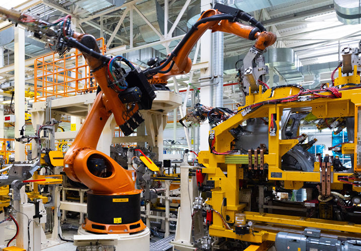 Moderne Fertigungslinie mit Robotern, stilvolle Technik und klare Ordnung, durch technische Versicherungen gesichert.